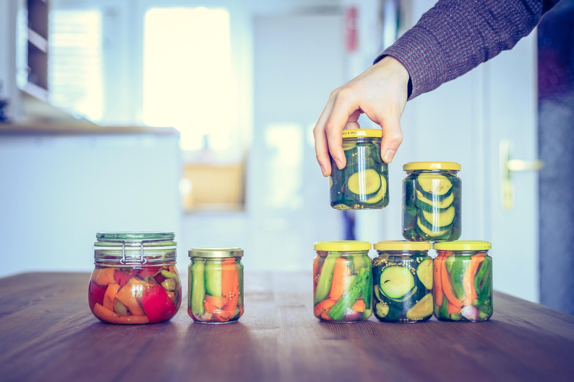 hands preparing preserves in a tidy workstation